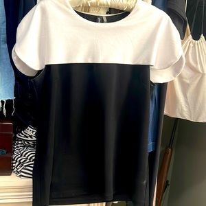 Gorgeous knit top. Sleeveless black bodice w/ white overlay w/light shouldr pads